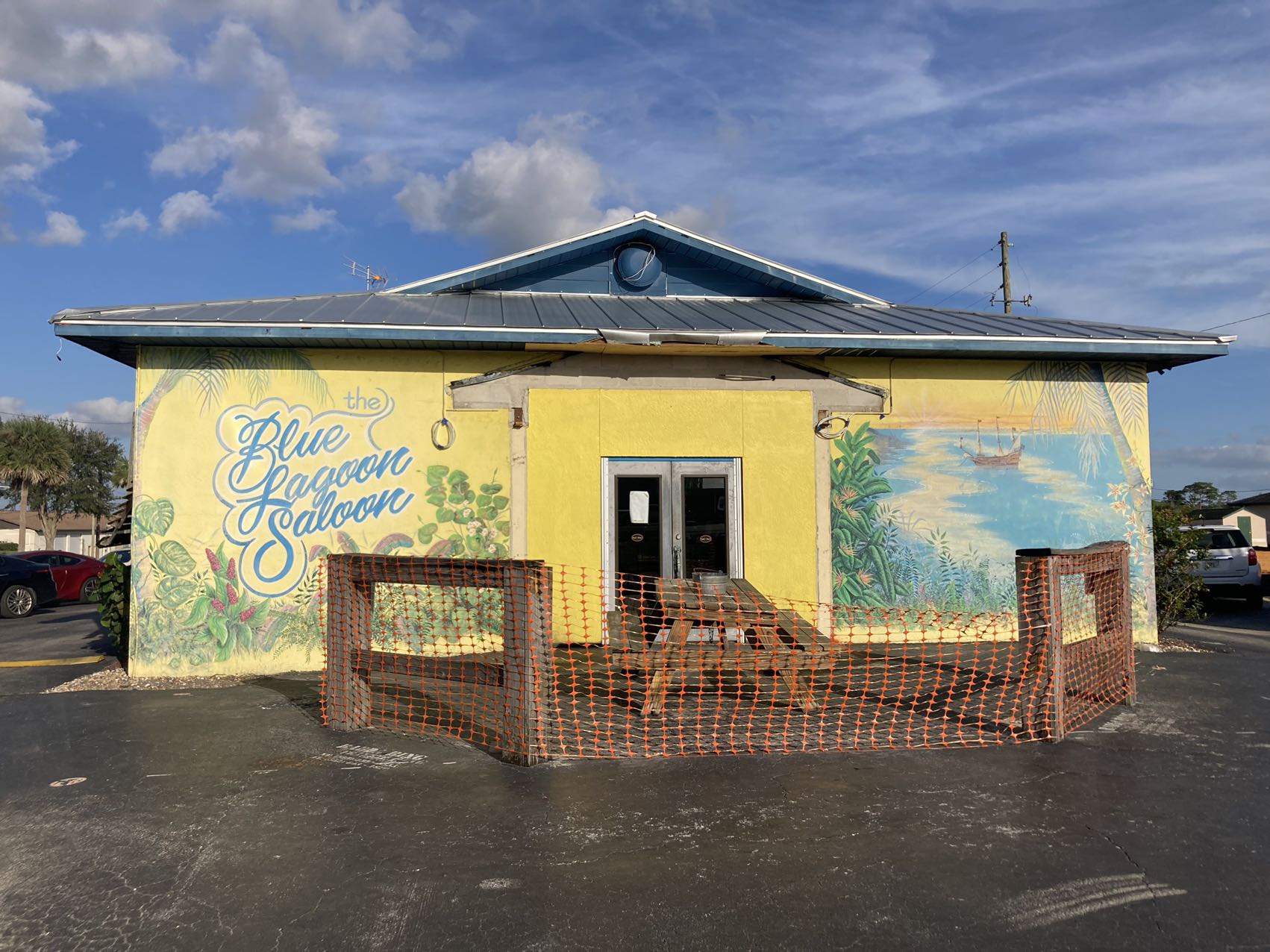 The Blue Lagoon Saloon storefront in Sebring, FL with its hand-painted tropical mural